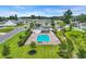 Aerial view of a community pool with lounge chairs, landscaping, and neighborhood streets, creating a resort-like experience at 446 Rycola Circle, Surfside Beach, SC 29575