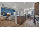 Open-concept kitchen features a large island with seating and modern appliances flowing into the living area at 446 Rycola Circle, Surfside Beach, SC 29575