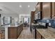Modern kitchen with stainless steel appliances, granite countertops, and a view into the adjacent dining area at 446 Rycola Circle, Surfside Beach, SC 29575