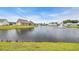 Scenic lake with a fountain surrounded by well-maintained homes and lush green lawns, creating a tranquil atmosphere at 446 Rycola Circle, Surfside Beach, SC 29575