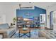 Cozy living room showcasing a blue accent wall, wood flooring and tasteful decor at 446 Rycola Circle, Surfside Beach, SC 29575