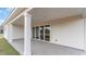 Covered patio with concrete flooring and support columns, leading to a sliding glass door at 509 Haven View Way, Murrells Inlet, SC 29576