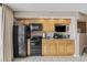 Compact kitchenette with wooden cabinets and modern appliances, designed for efficient meal preparation during your stay at 5308 N Ocean Blvd. # 1202, Myrtle Beach, SC 29577