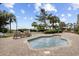 Inviting outdoor spa surrounded by brick patio, palm trees, and comfortable lounge chairs at 5308 N Ocean Blvd. # 1202, Myrtle Beach, SC 29577