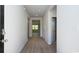 Bright hallway featuring sleek wood floors, fresh paint, and multiple doorways for easy access throughout the home at 556 Strawberry Field Way, Galivants Ferry, SC 29544