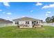 Well-kept backyard featuring a patio, lush green lawn, and white picket fence, ideal for outdoor activities at 568 Mossbank Loop, Longs, SC 29568