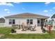 Backyard patio with outdoor furniture and lush lawn, creating a peaceful and inviting outdoor space at 568 Mossbank Loop, Longs, SC 29568