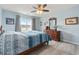 Bright bedroom with a full bed set, dresser, ceiling fan, and a view of the outside at 568 Mossbank Loop, Longs, SC 29568