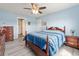 Cozy bedroom featuring a wooden bed, dresser, ceiling fan, and access to a walk-in closet at 568 Mossbank Loop, Longs, SC 29568