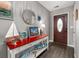 Entryway with red accent table featuring beach-themed decor, and a stylish mirror at 568 Mossbank Loop, Longs, SC 29568