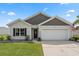 Charming single-story home with attached two-car garage, well-manicured lawn, and tasteful landscaping at 568 Mossbank Loop, Longs, SC 29568