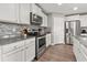 Modern kitchen with white cabinetry, stainless steel appliances, and granite countertops at 568 Mossbank Loop, Longs, SC 29568