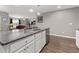 Modern kitchen island with gray countertops, stainless steel appliances, and open floorplan at 568 Mossbank Loop, Longs, SC 29568