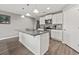 Well-lit kitchen features white cabinetry, stainless steel appliances, and a granite countertop island at 568 Mossbank Loop, Longs, SC 29568