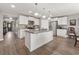 Bright kitchen featuring white cabinets, granite countertops, stainless steel appliances, and a functional center island at 568 Mossbank Loop, Longs, SC 29568