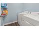 A well-equipped laundry room with washer, dryer, and shelving for storage at 568 Mossbank Loop, Longs, SC 29568