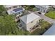 Aerial of a stilt home with light green paint, white trim and a metal roof surrounded by mature trees at 58 Fathom Ln., Murrells Inlet, SC 29576