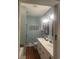 Well-lit bathroom featuring double sinks with a marble countertop, wooden framed mirrors, toilet, and modern shower at 58 Fathom Ln., Murrells Inlet, SC 29576