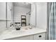 Stylish bathroom featuring shiplap walls, a modern vanity with a marble countertop, and a large mirror at 58 Fathom Ln., Murrells Inlet, SC 29576
