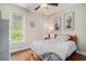 Bright bedroom with hardwood floors, coastal décor, and a large window offering natural light and a view at 58 Fathom Ln., Murrells Inlet, SC 29576