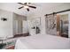 Primary bedroom features a barn door leading to bathroom, ceiling fan, and light-colored walls for a serene, inviting space at 58 Fathom Ln., Murrells Inlet, SC 29576
