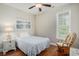 Relaxing bedroom with a cozy rocking chair, bedside table with lamp, and a tranquil view from the window at 58 Fathom Ln., Murrells Inlet, SC 29576