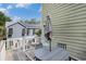 Outdoor deck with a gray dining set and views of the surrounding area and a charming beach house at 58 Fathom Ln., Murrells Inlet, SC 29576