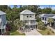 Charming stilt home with a metal roof, front balcony, well-manicured yard, and covered parking at 58 Fathom Ln., Murrells Inlet, SC 29576