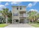 Stunning raised beach house with lush landscaping and covered parking, perfect for coastal living at 58 Fathom Ln., Murrells Inlet, SC 29576