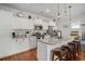 Well-lit kitchen features white cabinets, stainless steel appliances, granite countertops and a large island with barstool seating at 58 Fathom Ln., Murrells Inlet, SC 29576
