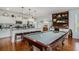 Stylish kitchen open to living area featuring a pool table, white cabinets, and granite countertops at 58 Fathom Ln., Murrells Inlet, SC 29576