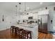 Modern kitchen with white cabinets, stainless steel appliances, granite countertops, and bar stool seating at 58 Fathom Ln., Murrells Inlet, SC 29576