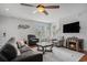 Cozy living room with plush seating, decorative fireplace, and natural light streaming through the windows at 58 Fathom Ln., Murrells Inlet, SC 29576