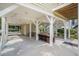 Spacious covered parking area with outdoor seating, storage room, and easy access stairs at 58 Fathom Ln., Murrells Inlet, SC 29576