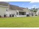 Spacious backyard with lush green lawn and view of the rear of the property at 592 Riverward Dr. # 592, Myrtle Beach, SC 29588