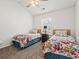 Bright bedroom featuring two twin beds, floral bedding, and a ceiling fan at 592 Riverward Dr. # 592, Myrtle Beach, SC 29588