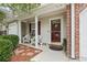 Inviting front porch with wicker chairs and decorative plants enhance the home's curb appeal at 592 Riverward Dr. # 592, Myrtle Beach, SC 29588