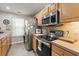 Modern kitchen with stainless steel appliances, bright countertops, and wood cabinets at 592 Riverward Dr. # 592, Myrtle Beach, SC 29588