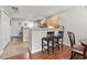 Kitchen and bar area with wood floors, lighting, and two stools ready for a meal at 592 Riverward Dr. # 592, Myrtle Beach, SC 29588