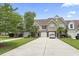Charming townhomes feature attached garages, manicured lawns and mature trees under a bright blue sky at 592 Riverward Dr. # 592, Myrtle Beach, SC 29588