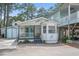 Charming beach home with a cozy front porch, white siding, and whimsical lizard accents at 6001-1623 S Kings Hwy., Myrtle Beach, SC 29575