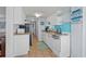 Functional kitchen featuring white cabinets, a turquoise backsplash, and essential appliances at 6001-1623 S Kings Hwy., Myrtle Beach, SC 29575