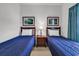 A view of the well-lit bedroom highlighting the two beds, accent paintings, and a centered nightstand at 6015 Catalina Dr. # 733, North Myrtle Beach, SC 29582