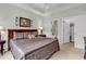 Bedroom featuring a tray ceiling and adjacent doorways leading to an en-suite bathroom at 6015 Catalina Dr. # 733, North Myrtle Beach, SC 29582