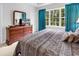 Bedroom showcasing a large window and a mirrored dresser with a television on top at 6015 Catalina Dr. # 733, North Myrtle Beach, SC 29582