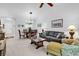 Open-concept dining area with chandelier lighting next to a gray couch and a floral armchair at 6015 Catalina Dr. # 733, North Myrtle Beach, SC 29582