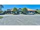 Well-maintained building with ample parking, lush landscaping, and a welcoming entrance under a clear sky at 6015 Catalina Dr. # 733, North Myrtle Beach, SC 29582