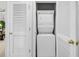 Laundry closet featuring a stacked washer and dryer unit behind white louvered doors at 6015 Catalina Dr. # 733, North Myrtle Beach, SC 29582