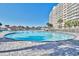 Large outdoor pool with a white fence, red cabana, and surrounding sun deck with oceanfront tower views at 6015 Catalina Dr. # 733, North Myrtle Beach, SC 29582