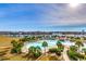 Aerial view of an attractive outdoor pool area with palm trees and stunning views of the city skyline at 6015 Catalina Dr. # 733, North Myrtle Beach, SC 29582